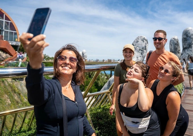 Traveler taking photo on Da Nang beach while using phone with eSIM connection